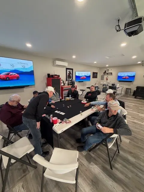 Men playing cards in home game room