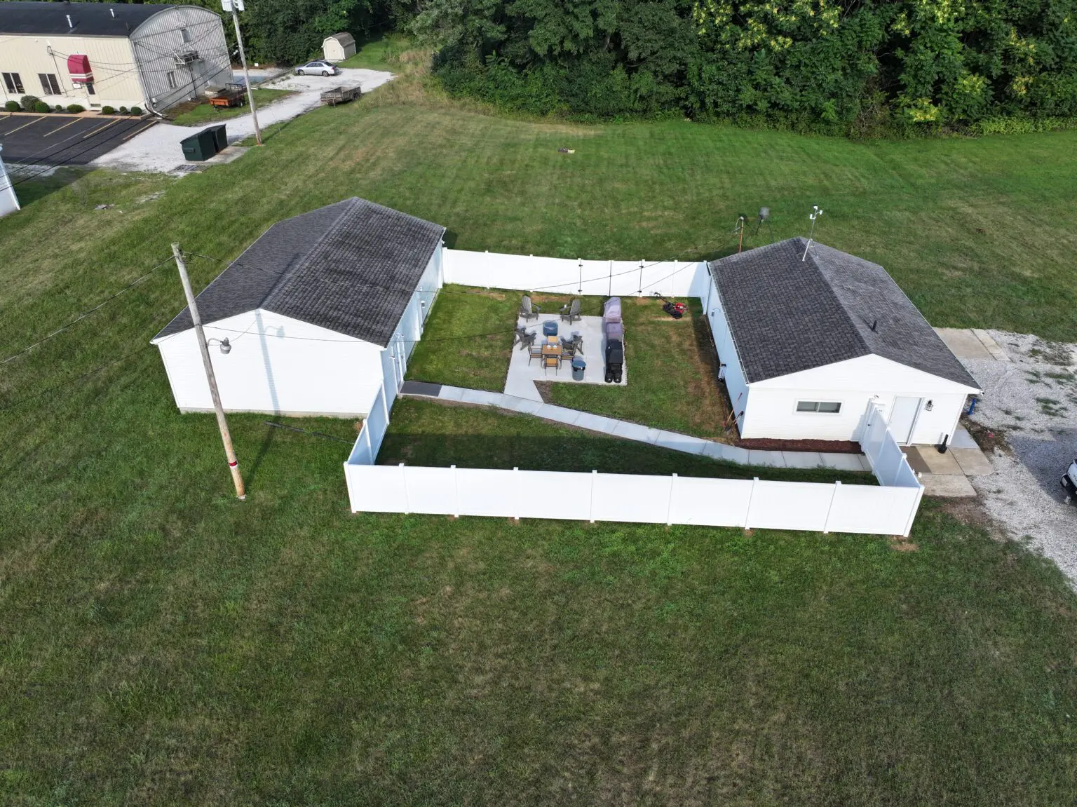 Aerial view of fenced yard between two buildings