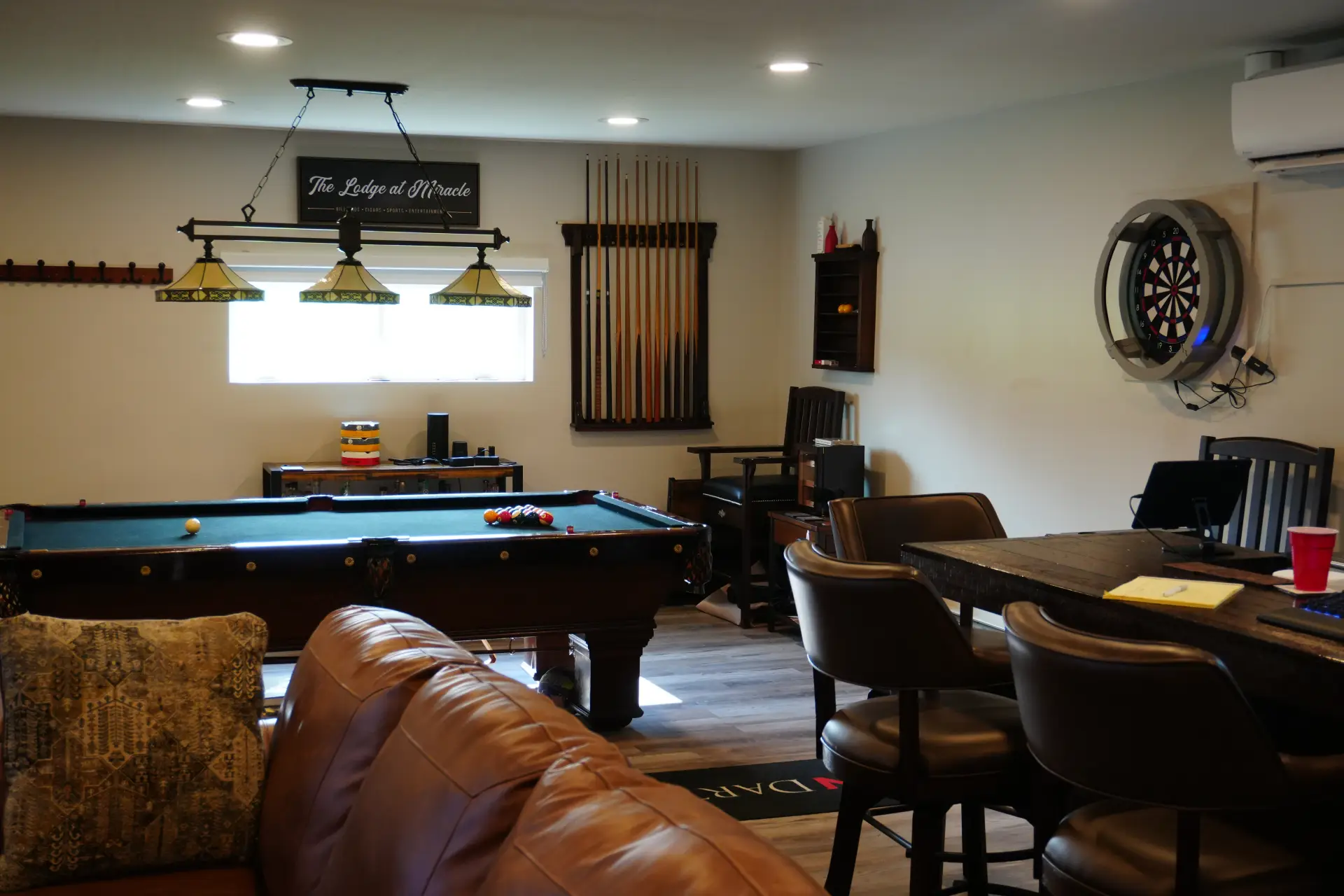 Cozy game room with pool table and dartboard