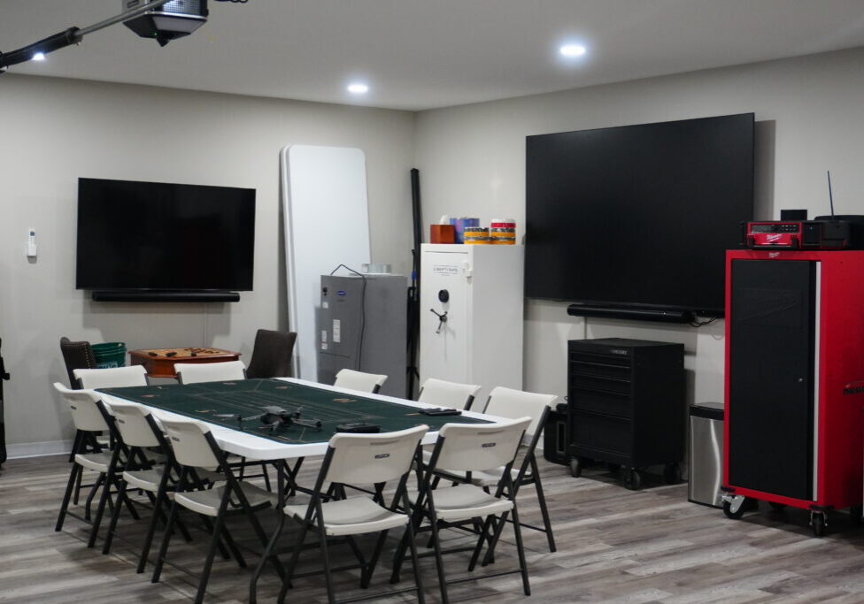 Game room with table, folding chairs, TVs